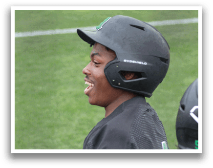 A baseball player wearing a black helmet and a green jersey. Description generated by AI