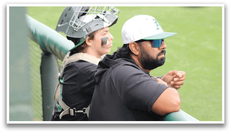 A man wearing a black shirt and a baseball cap. Description generated by AI