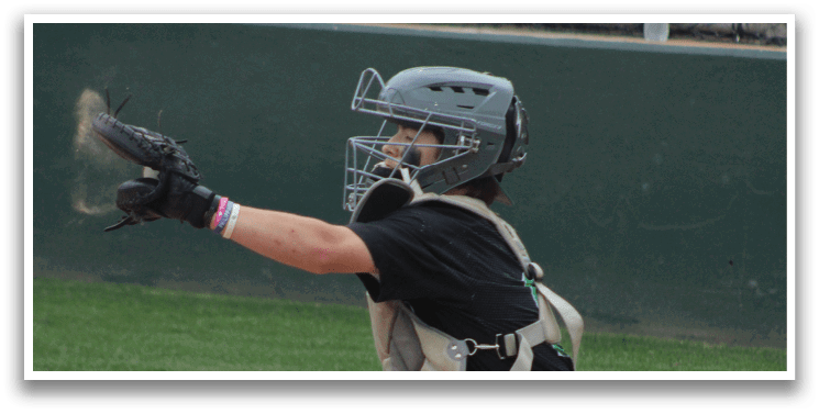 A baseball player is wearing a helmet and kneeling on the ground. Description generated by AI