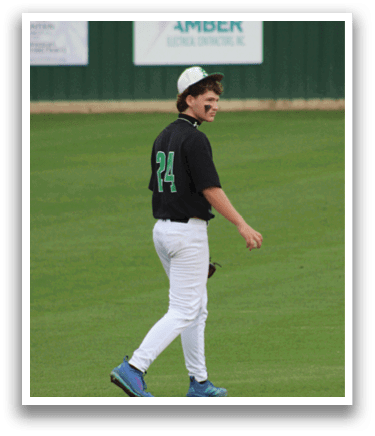 A baseball player wearing a black shirt and white pants. Description generated by AI