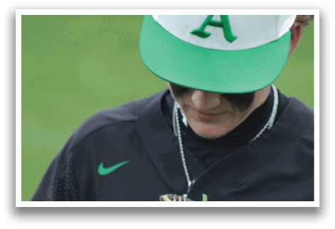 A baseball player wearing a green and black jersey with the number 24. Description generated by AI