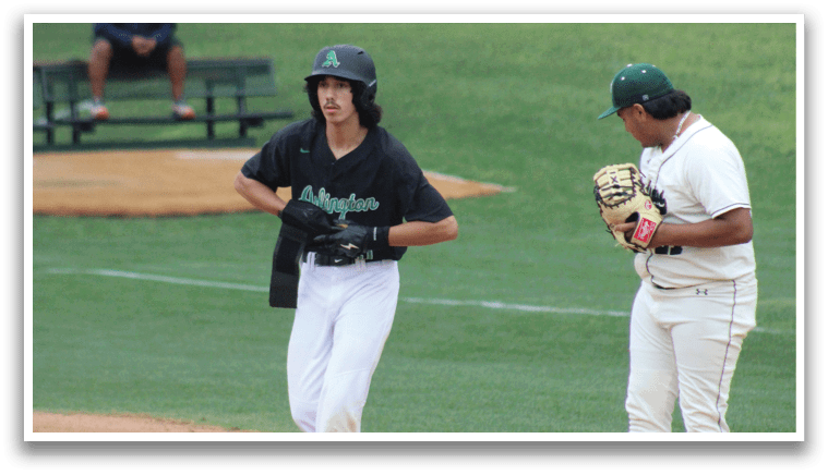 A baseball player in a black shirt and white pants is running to first base. Description generated by AI