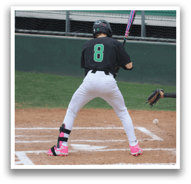 A baseball player in a black shirt and white pants is holding a bat and getting ready to hit a ball. Description generated by AI