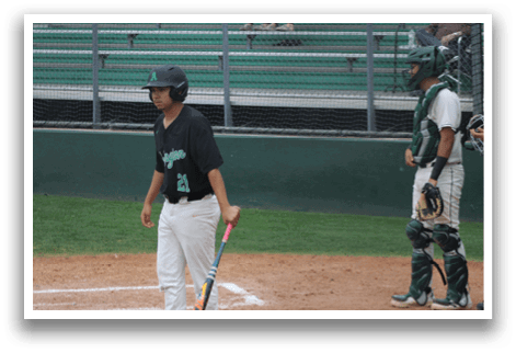 A baseball player holding a bat. Description generated by AI
