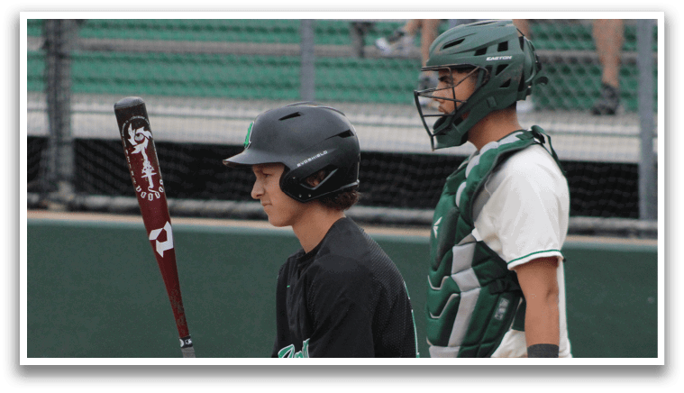 A baseball player holding a bat. Description generated by AI