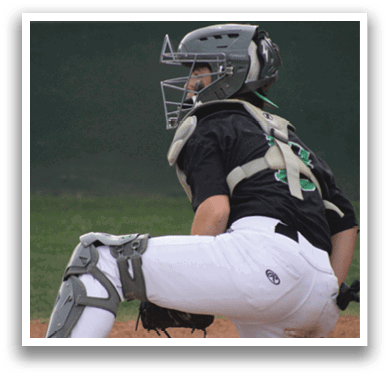 A baseball player wearing a helmet and catcher's gear. Description generated by AI