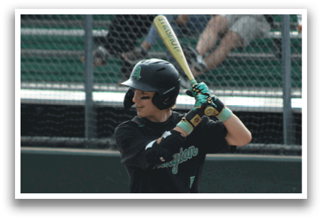 A baseball player in a black and white uniform holding a bat. Description generated by AI