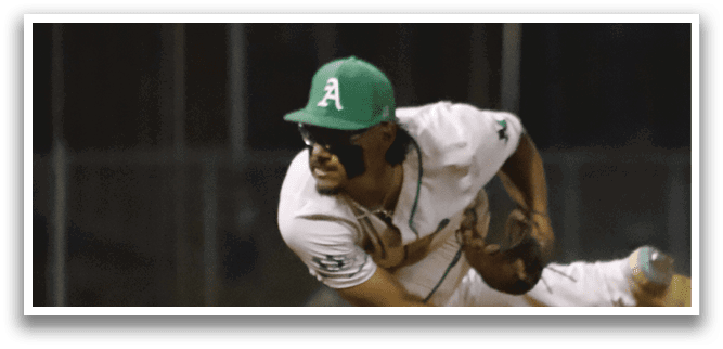 A baseball player wearing a green hat and white uniform. Description generated by AI