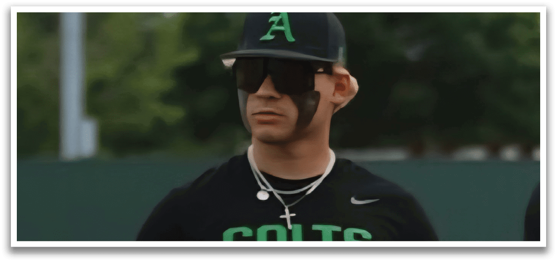 A baseball player wearing a black shirt with the word “Colts" on it. Description generated by AI