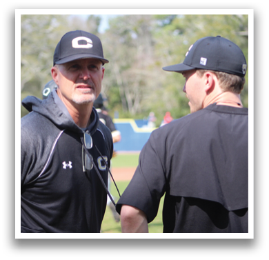 Two men wearing black shirts are talking to each other. One man is wearing a black hat and the other is wearing a black shirt. AI generated content