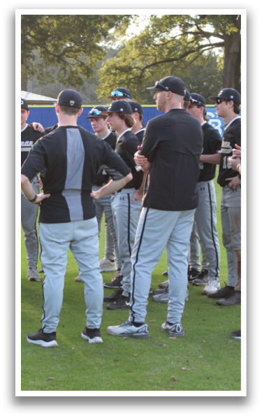 A group of baseball players wearing black and grey uniforms are standing on a field. AI generated content