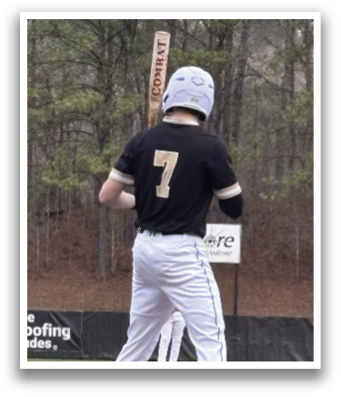 A baseball player in a black and white uniform is holding a bat and standing at home plate. AI generated content