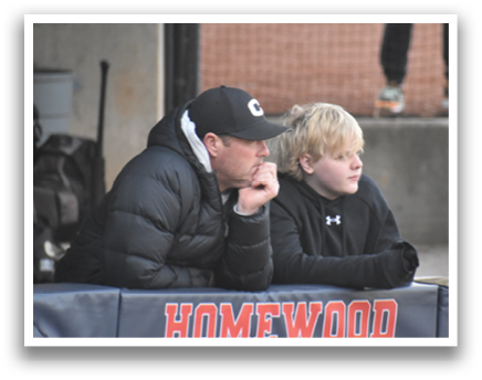 A man and a boy are sitting on a bench, both wearing black jackets. The man is wearing a baseball cap and has his hand on his chin. The boy is sitting next to him, also wearing a baseball cap. AI generated content