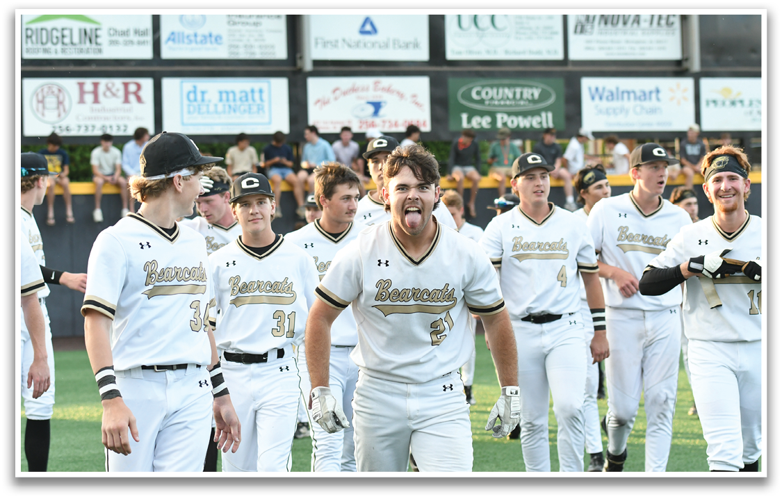 A group of baseball players wearing white uniforms. Description generated by AI