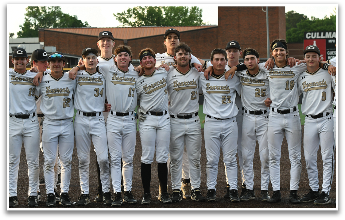 Baseball players in white uniforms. Description generated by AI