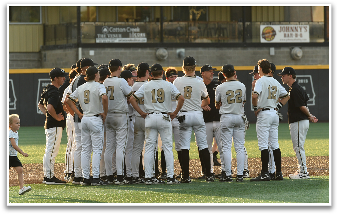 A group of baseball players standing on a field. Description generated by AI