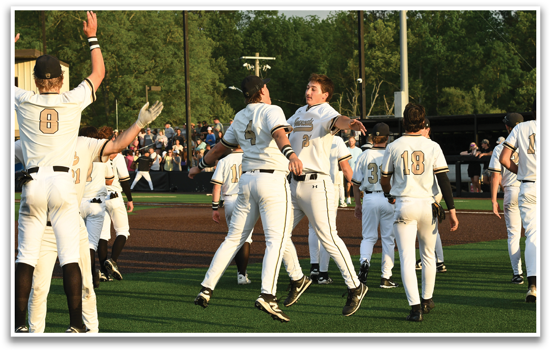 A group of baseball players celebrating a win. Description generated by AI