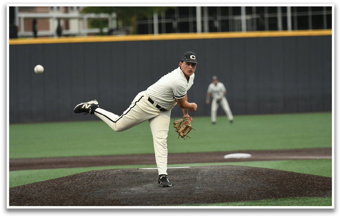 A baseball player in a white uniform is pitching a ball. Description generated by AI