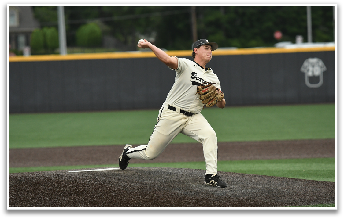 A baseball player in a white uniform is pitching a ball. Description generated by AI