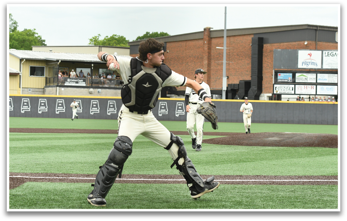 A baseball player in a black and white uniform is swinging a bat. Description generated by AI