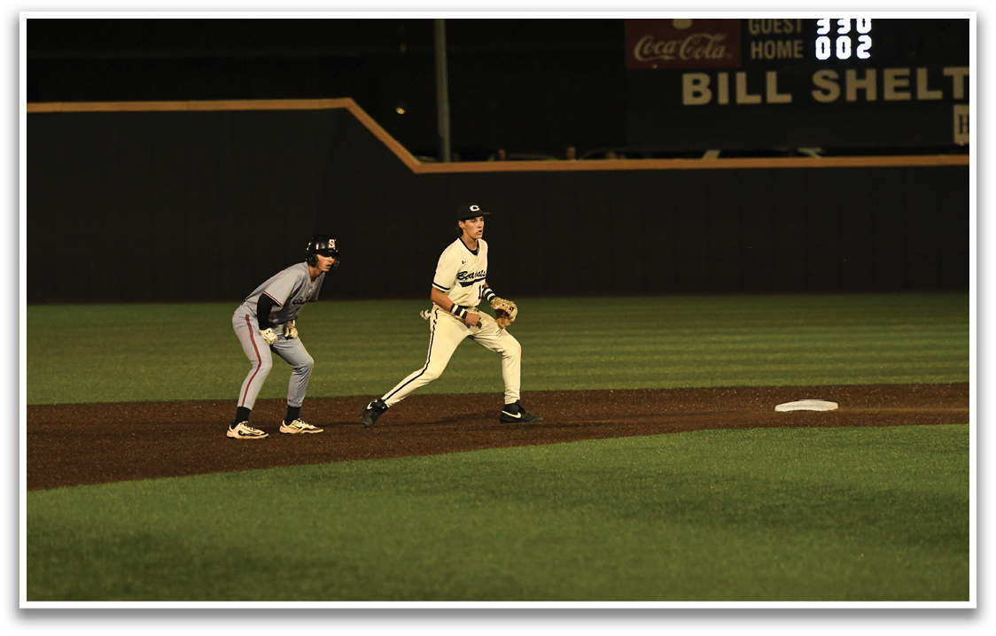 A baseball player running to a base. Description generated by AI