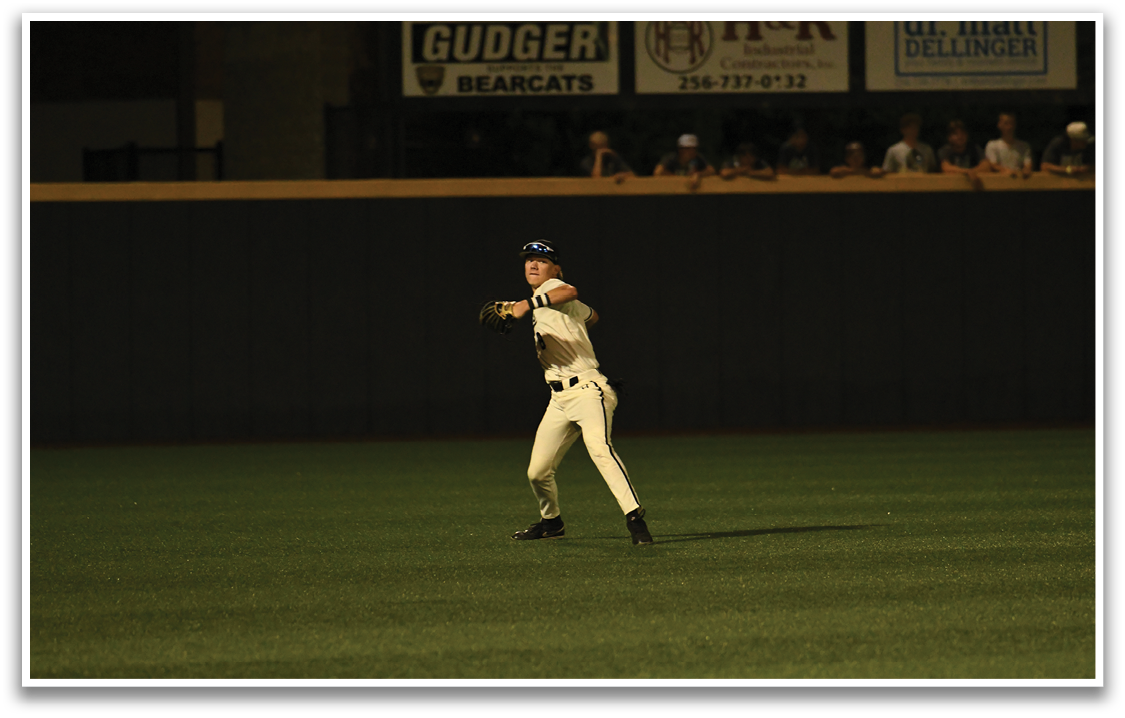 A baseball player in a white uniform is throwing a ball. Description generated by AI