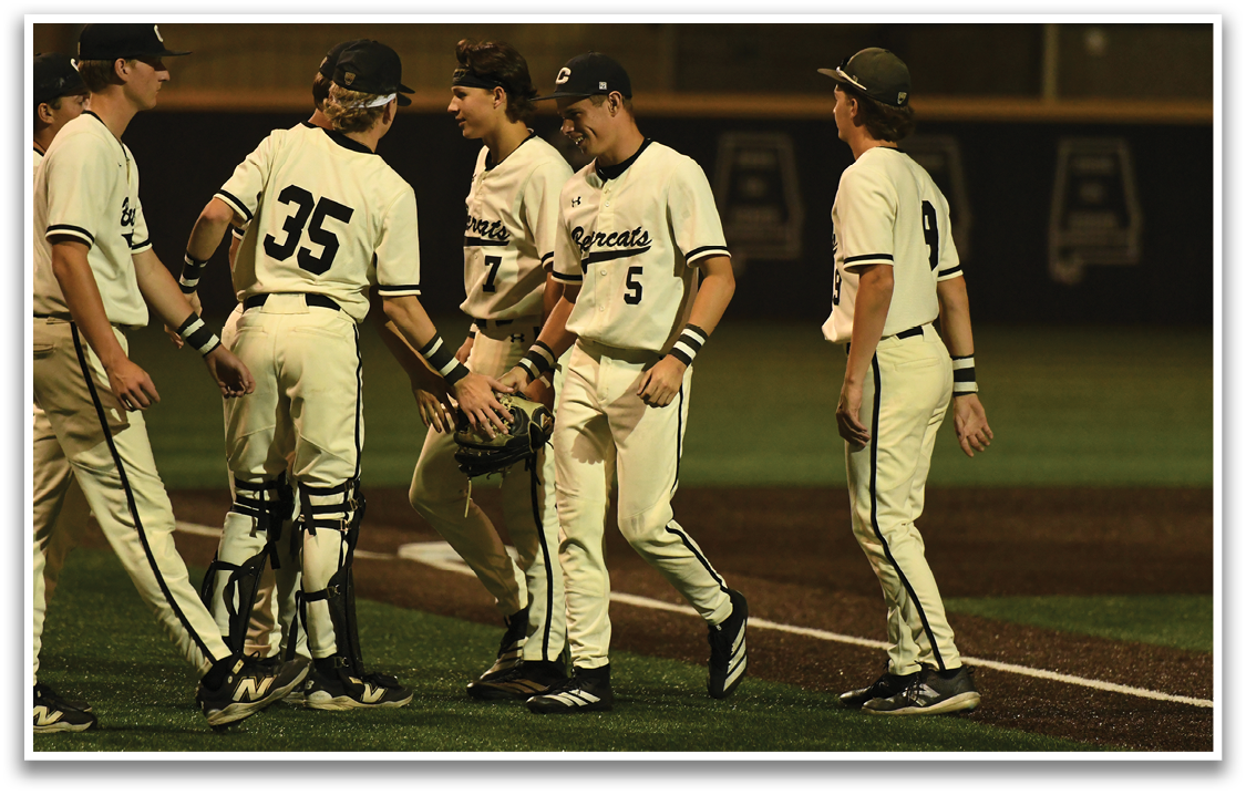 A group of baseball players on a field. Description generated by AI
