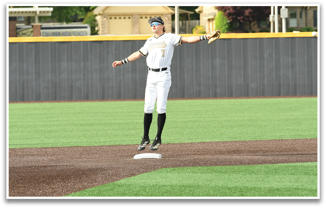 A baseball player is standing on a base. Description generated by AI