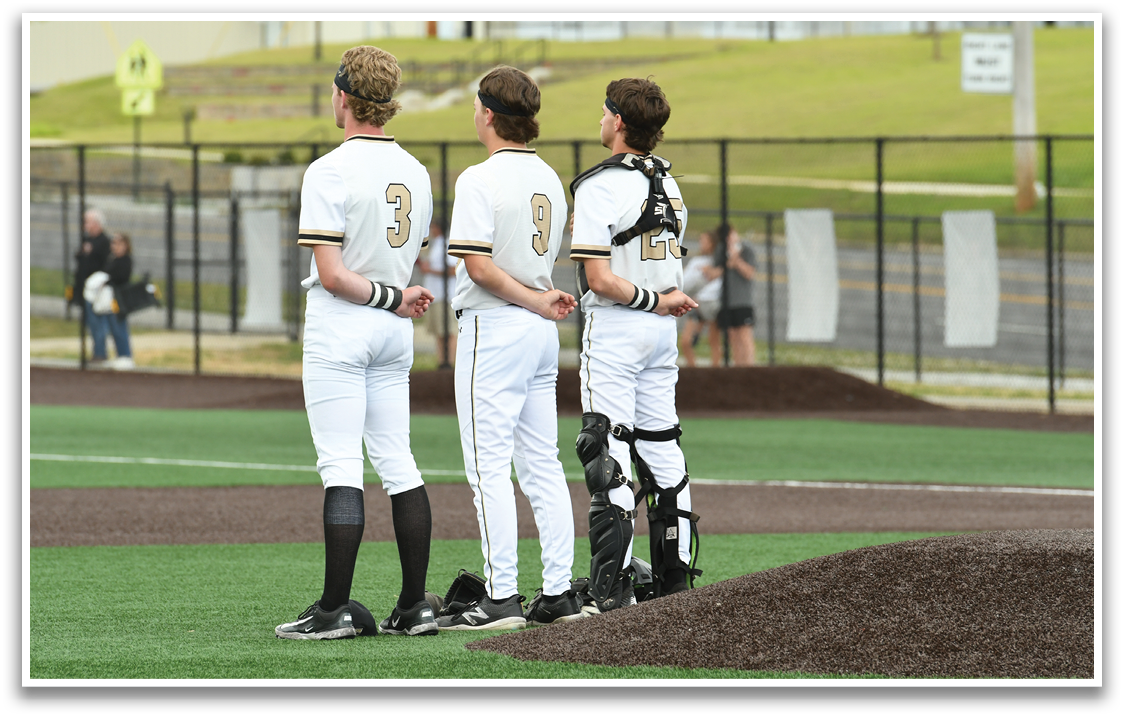 Three baseball players standing on a field. Description generated by AI