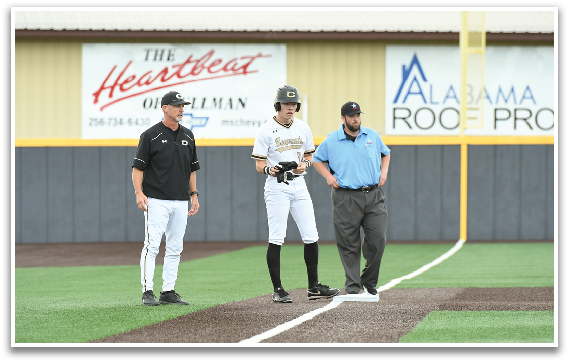A baseball game is taking place with three people on the field. Description generated by AI