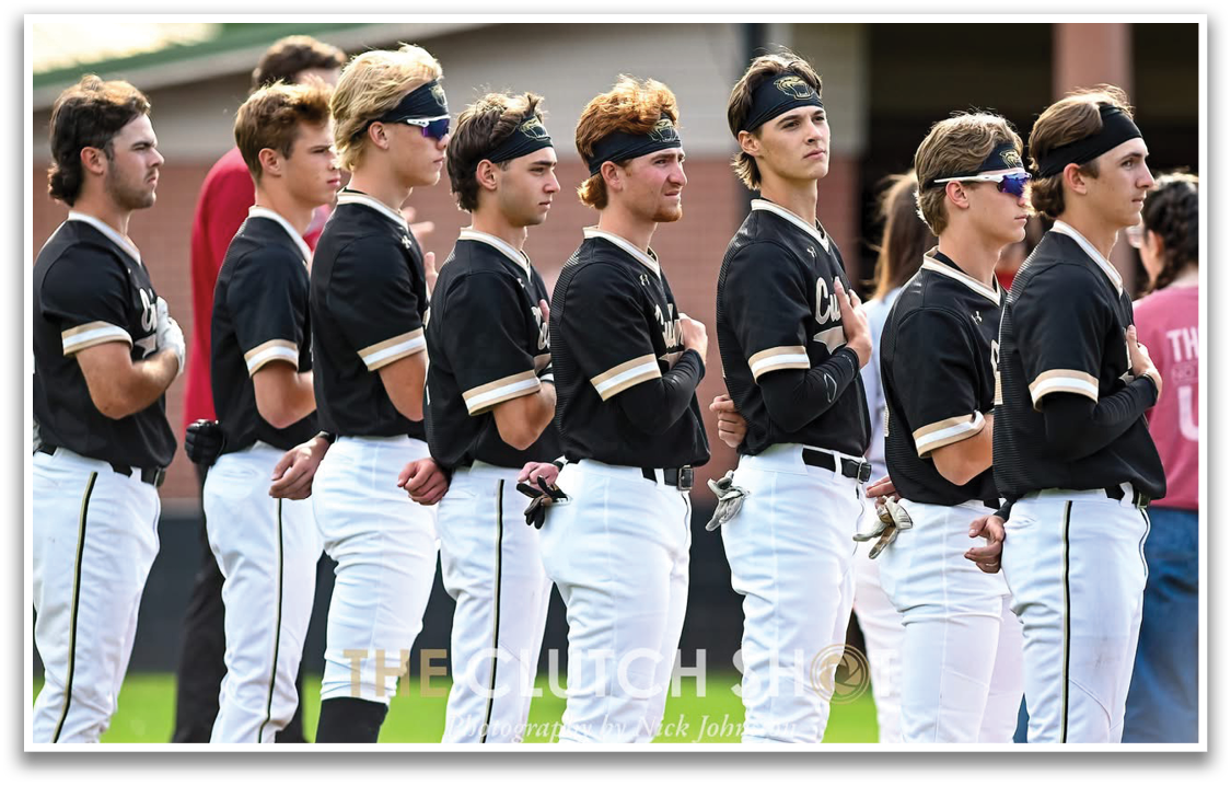A group of young men wearing black and white uniforms. Description generated by AI