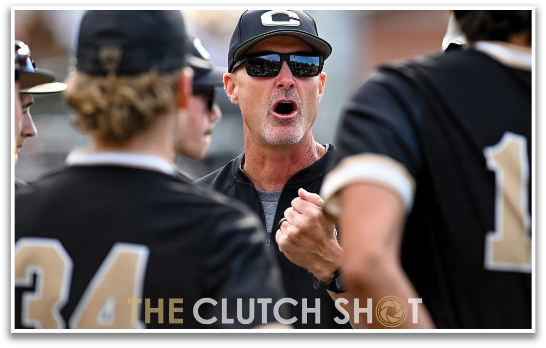 A group of baseball players wearing black and gold uniforms. Description generated by AI
