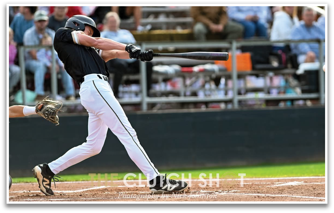 A baseball player is swinging a bat at a ball. Description generated by AI