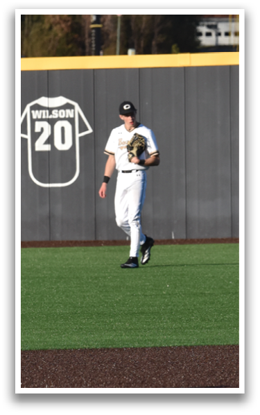 Two baseball players are standing on a field, one of them wearing a jersey with the number 22. AI generated content
