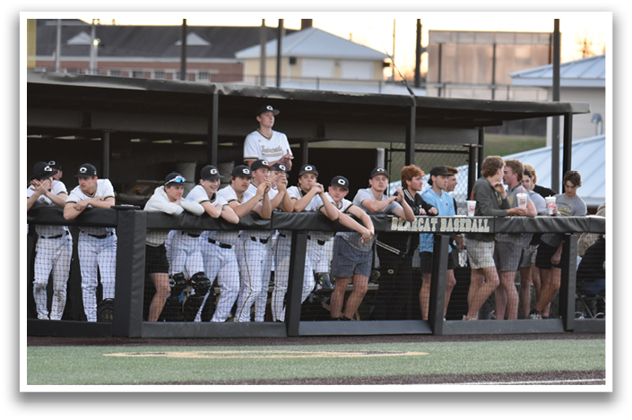 A baseball team is sitting on the bench, watching the game. AI generated content