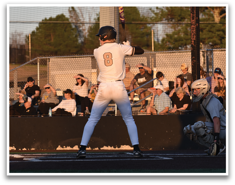 A baseball player is at bat, holding a bat and preparing to swing. AI generated content