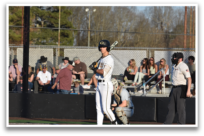 A baseball player is holding a bat, getting ready to hit the ball. AI generated content
