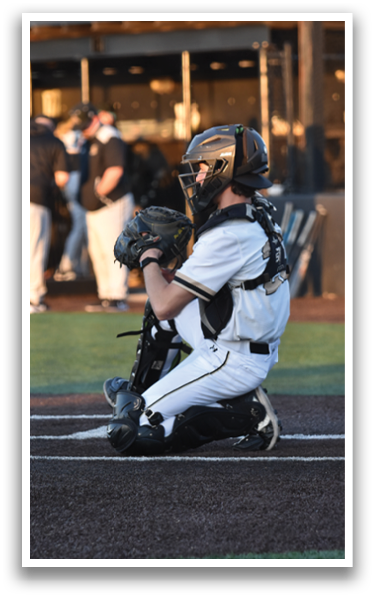 A baseball player is sitting on the ground with his catcher's mitt on. AI generated content