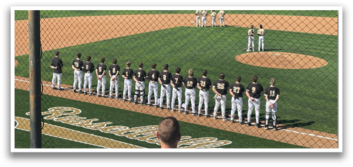 Baseball players on a field, some standing and some kneeling, with a man in a black shirt and white pants standing in front of them. AI generated content