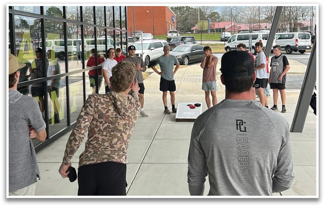 A group of people are playing a game of frisbee in a parking lot. AI generated content