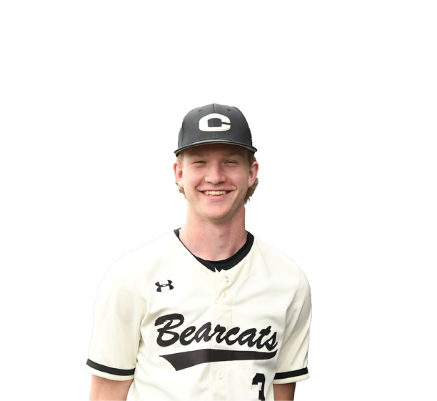 A young man wearing a baseball uniform stands in front of a sign. AI generated content