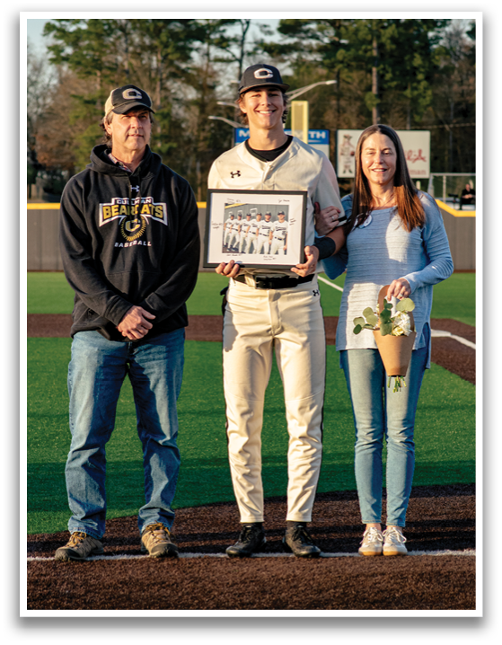 A man and woman are standing on a baseball field, with the man holding a baseball bat. The woman is holding a bouquet of flowers. AI generated content