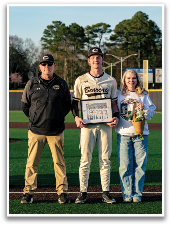 A baseball player is holding a framed photo while standing next to two men. AI generated content