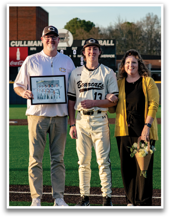 A man and woman pose with a baseball player in front of a scoreboard. AI generated content