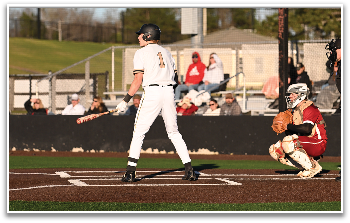 A baseball player is at bat, holding a bat and getting ready to swing. The catcher is positioned behind him, wearing a baseball glove. There are several other people in the scene, some of whom are sitting on a bench. AI generated content
