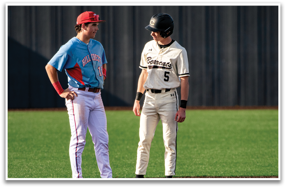 Two baseball players wearing uniforms and red hats are standing on the field. AI generated content