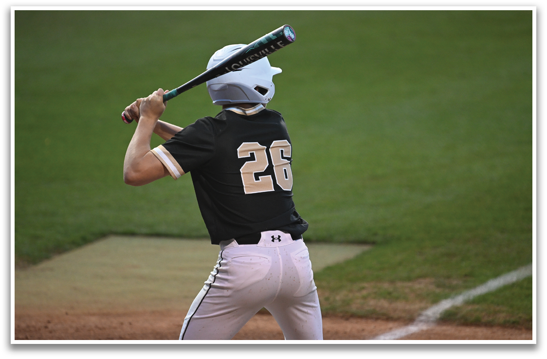 A baseball player in a black and gold uniform is swinging a bat on a field. AI generated content