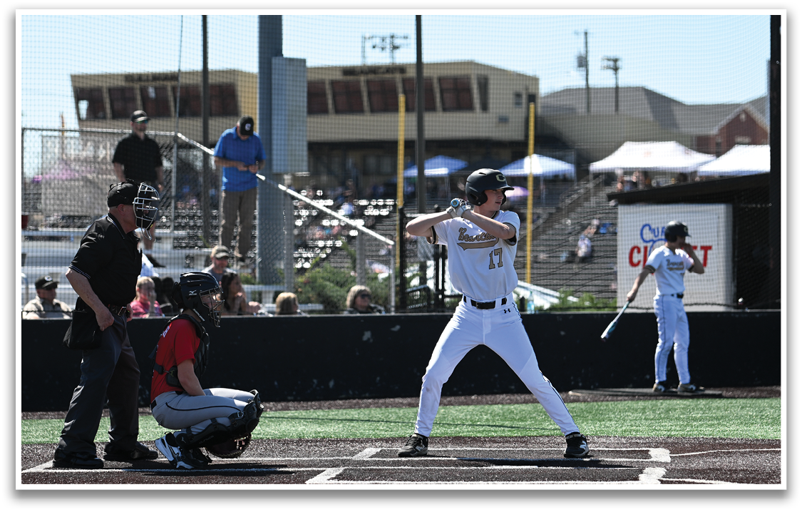 A baseball player is at home plate, holding a bat and preparing to swing. AI generated content