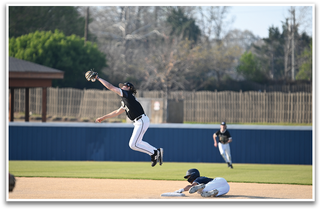 A baseball player catches a ball in the air. AI generated content