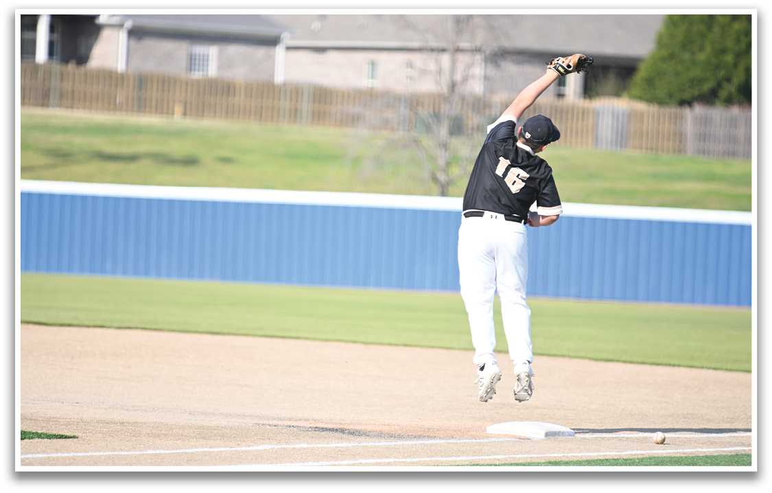 A baseball player in a black and white uniform jumps in the air to catch a ball. AI generated content